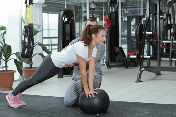 Rehabilitation concept. Young woman doing exercises under physiotherapist supervision