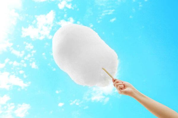 Женщина держит сахарную вату
