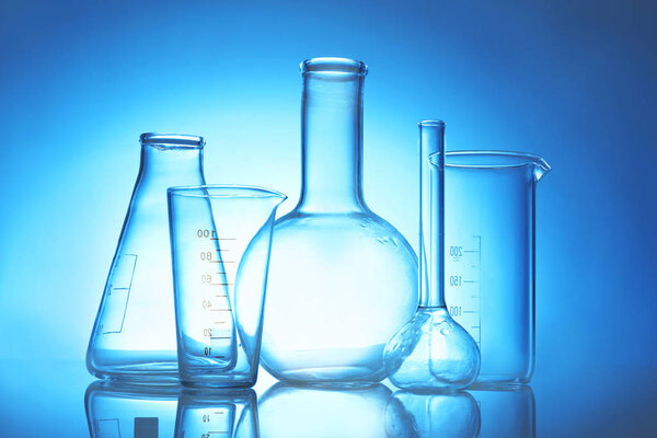 Test beakers and flasks on color background