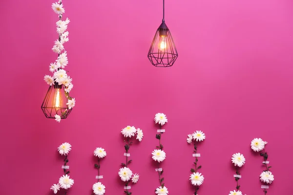 Lâmpadas e parede decorados com guirlanda flor — Fotografia de Stock