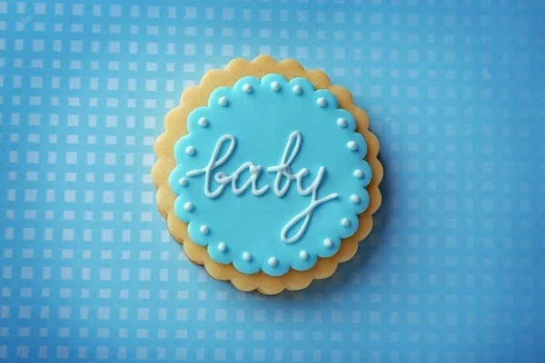 Baby cookie decorated with glaze on color background — Stock Photo, Image