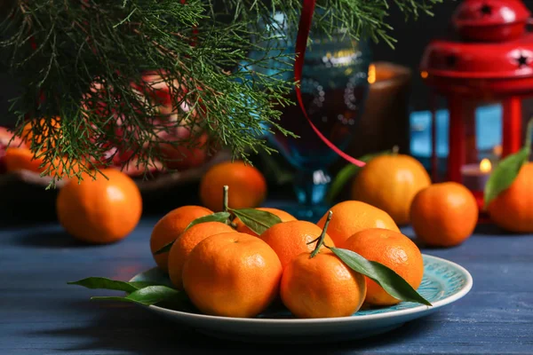 Tangerine in plate on blurred background — Stock Photo, Image