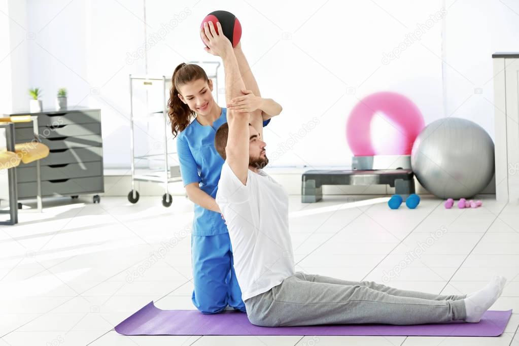 Physiotherapist working with patient in clinic