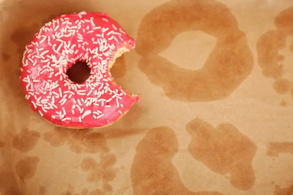 Delicious donut on greasy paper