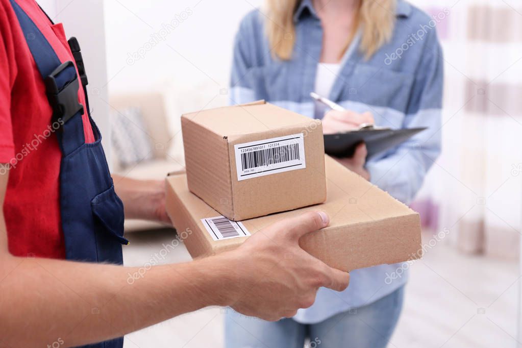 Young woman signing for package 