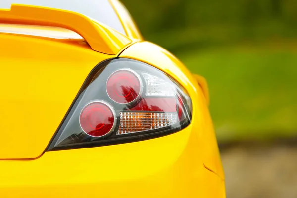 Rear light of yellow car, closeup — Stock Photo, Image