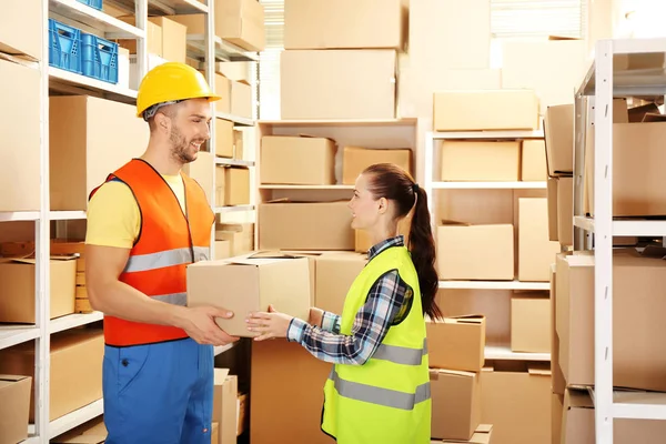 Two business people at warehouse