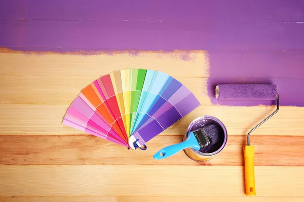 Painting roller, purple paint can and color palette — Stock Photo, Image