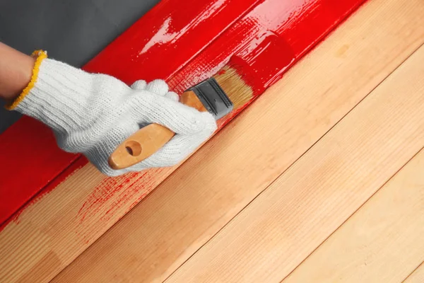 Hand painting surface with red paint — Stock Photo, Image