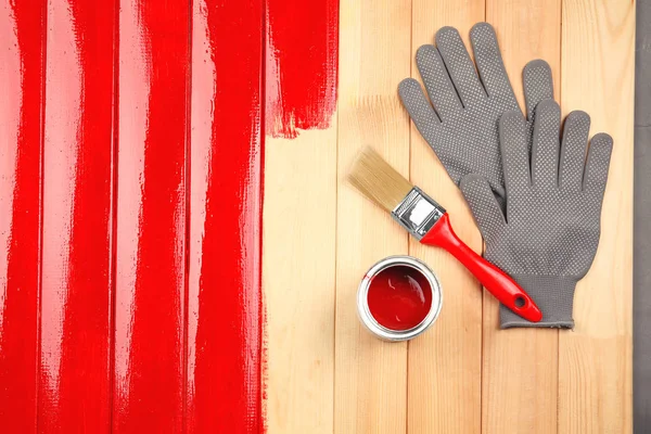 Paint can with gloves and brush — Stock Photo, Image