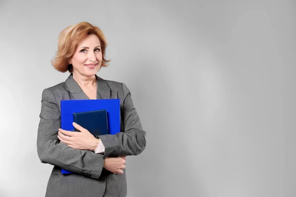 Attractive senior woman holding folder — Stock Photo, Image