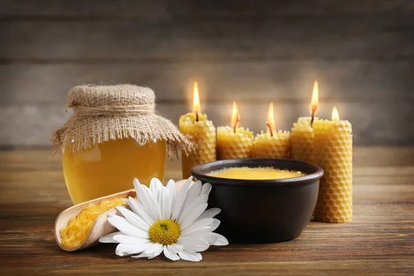 Honey with sea salt and wax candles — Stock Photo, Image