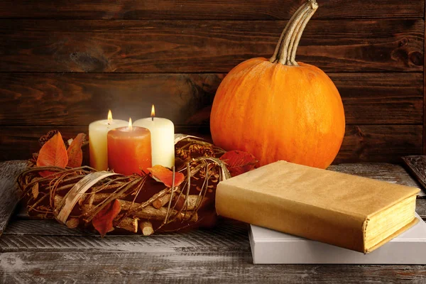 autumn composition with pumpkin and books