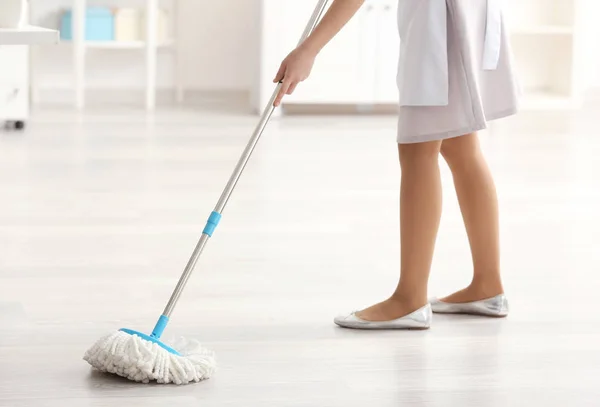 Young charwoman moping floor — Stok Foto