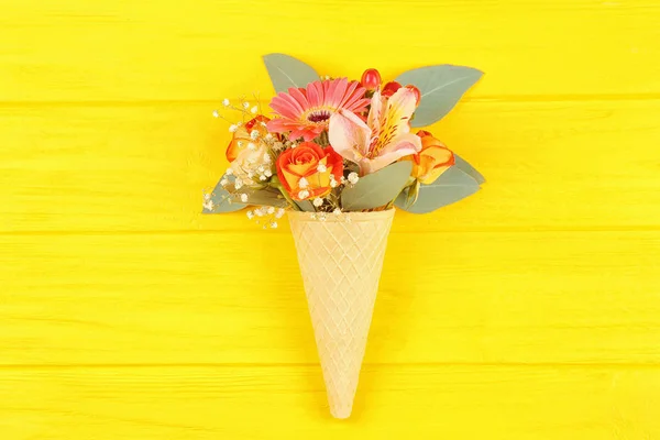 Waffle cone with composition of flowers — Stock Photo, Image