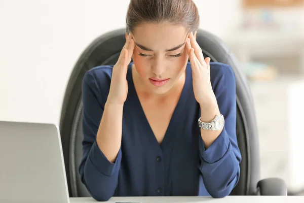 Young woman sitting in office Stock Photo