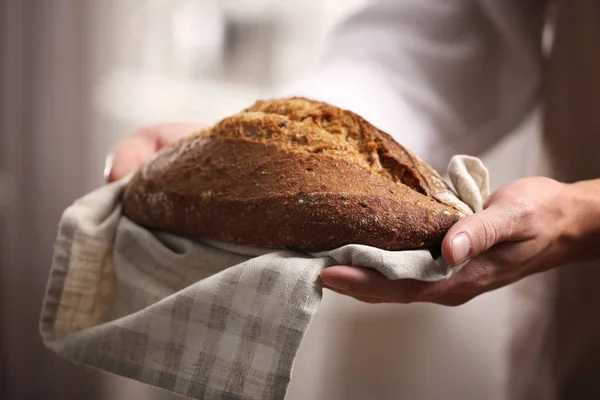 Mani maschili con pane appena cotto — Foto Stock