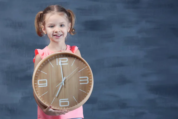Cute little girl with big clock — Stock Photo, Image