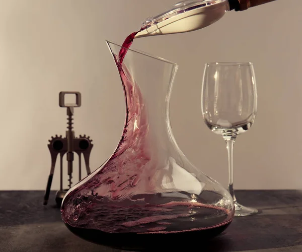 Pouring wine in carafe — Stock Photo, Image