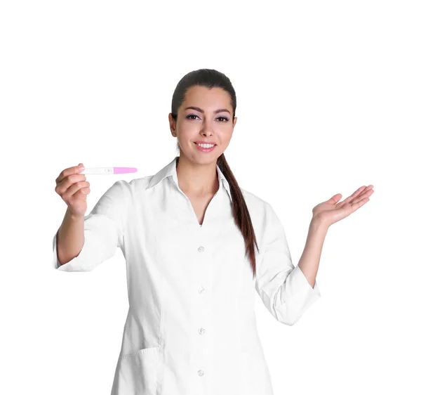 Beautiful doctor holding pregnancy test on white background — Stock Photo, Image