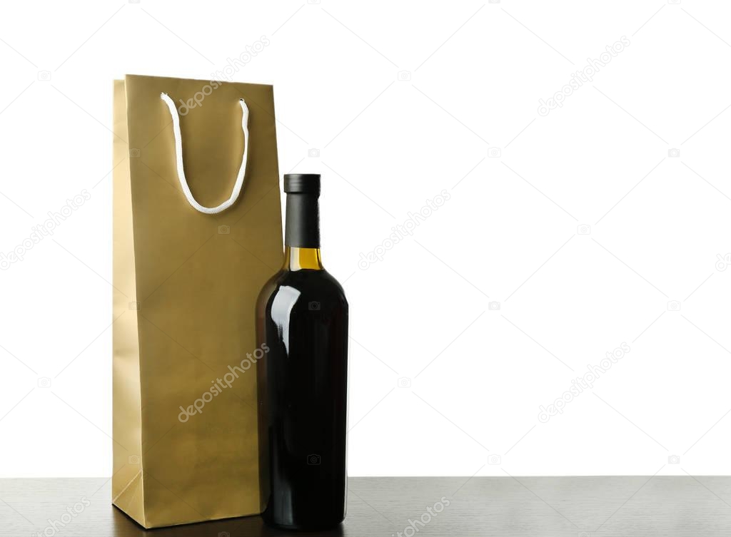 Wine bottle and gift bag on white background