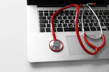 Modern laptop and stethoscope clipart