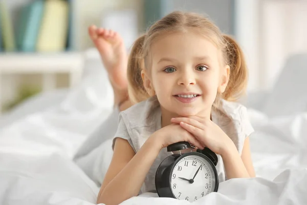 Little girl with alarm clock — Stock Photo, Image