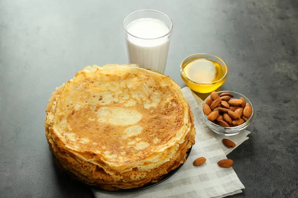 Pancakes, almonds, honey and glass of milk — Stock Photo, Image