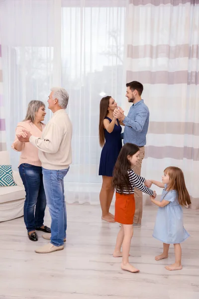 Happy big family dancing in the room