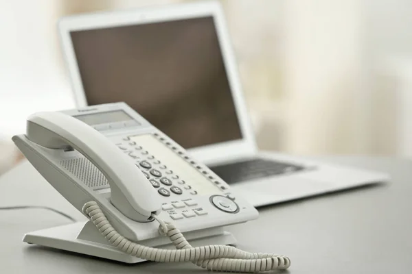 Telephone and modern laptop — Stock Photo, Image