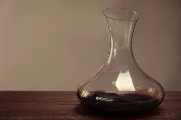 Glass carafe of red wine on  table