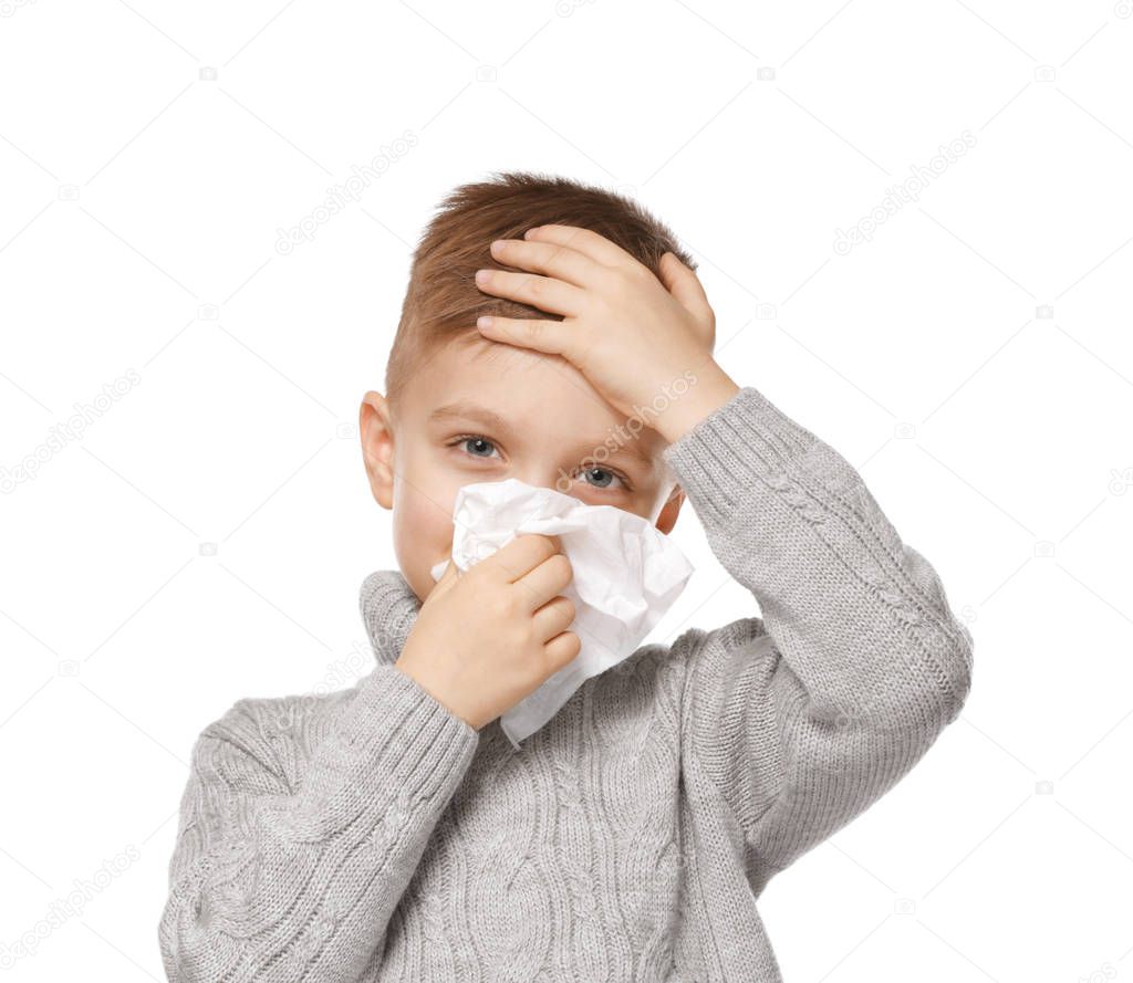 little boy blowing nose 