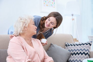 Güzel kız ve Cilt Bakımı almayı büyükanne evde kanepe