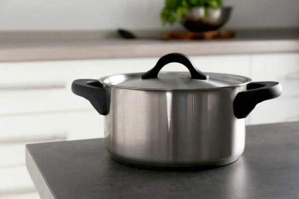 Metal saucepan on table — Stock Photo, Image