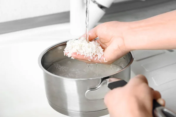 Woman rinsing rice — Stock Photo, Image