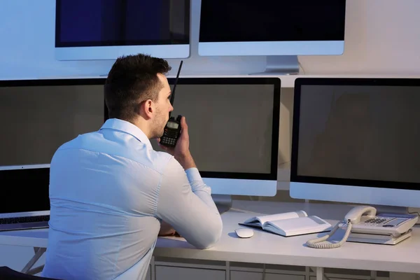 Handsome security guard in surveillance room — Stock Photo, Image