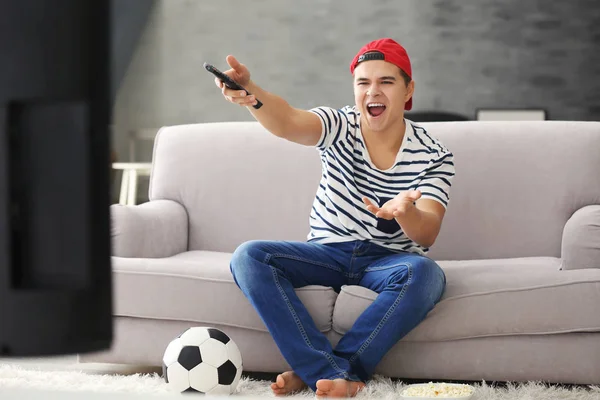 Teenager watching football match