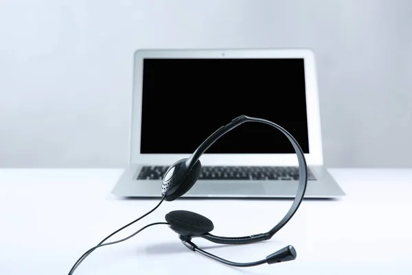 Open laptop with headset — Stock Photo, Image