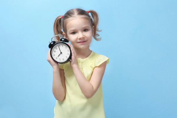 Little girl with alarm clock — Stock Photo, Image