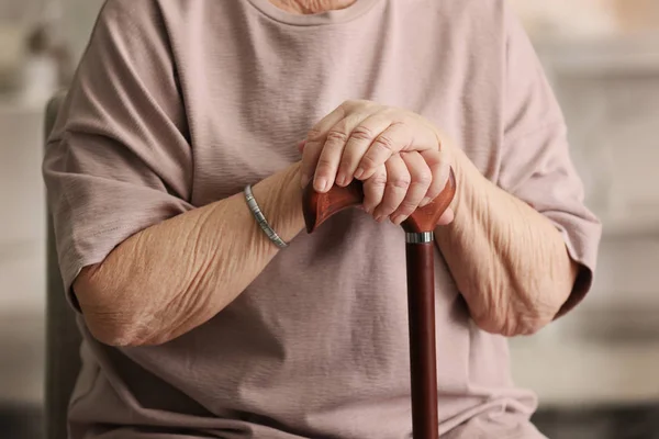 Female hands on walking stick — Stock Photo, Image