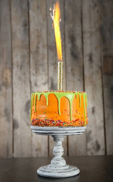 Tasty birthday cake with firework — Stock Photo, Image