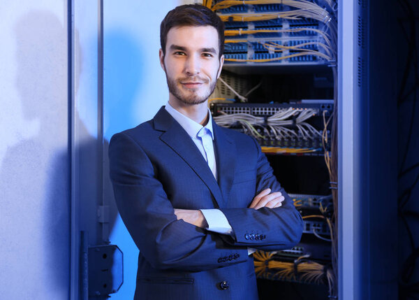 Handsome young engineer in server room