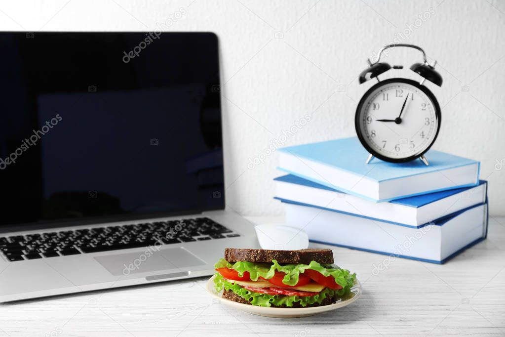 Plate with sandwich and alarm clock 
