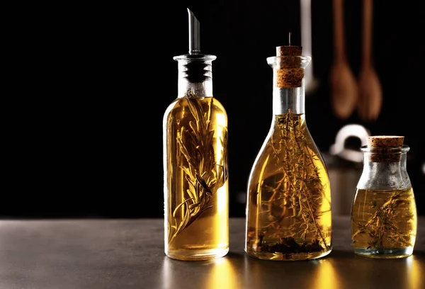 Bottles with oil on table — Stock Photo, Image