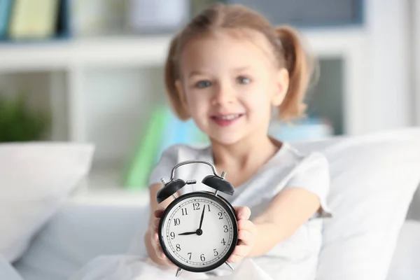 Little girl with alarm clock — Stock Photo, Image