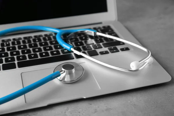 Modern laptop and stethoscope — Stock Photo, Image