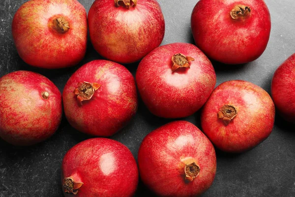 Whole pomegranates on table — Stock Photo, Image