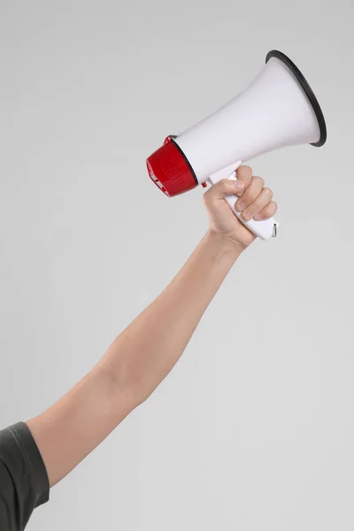 Male hand holding megaphone — Stock Photo, Image