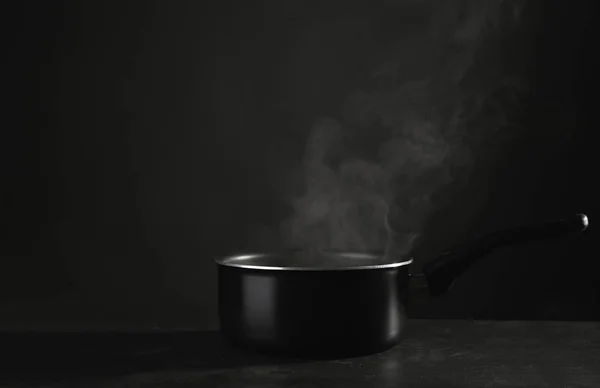 Saucepan with hot liquid — Stock Photo, Image