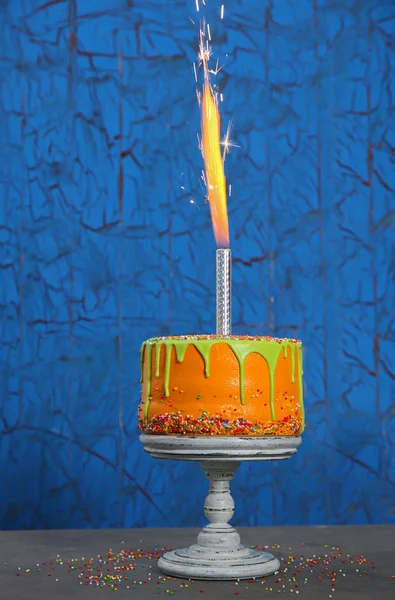Tasty birthday cake with firework — Stock Photo, Image